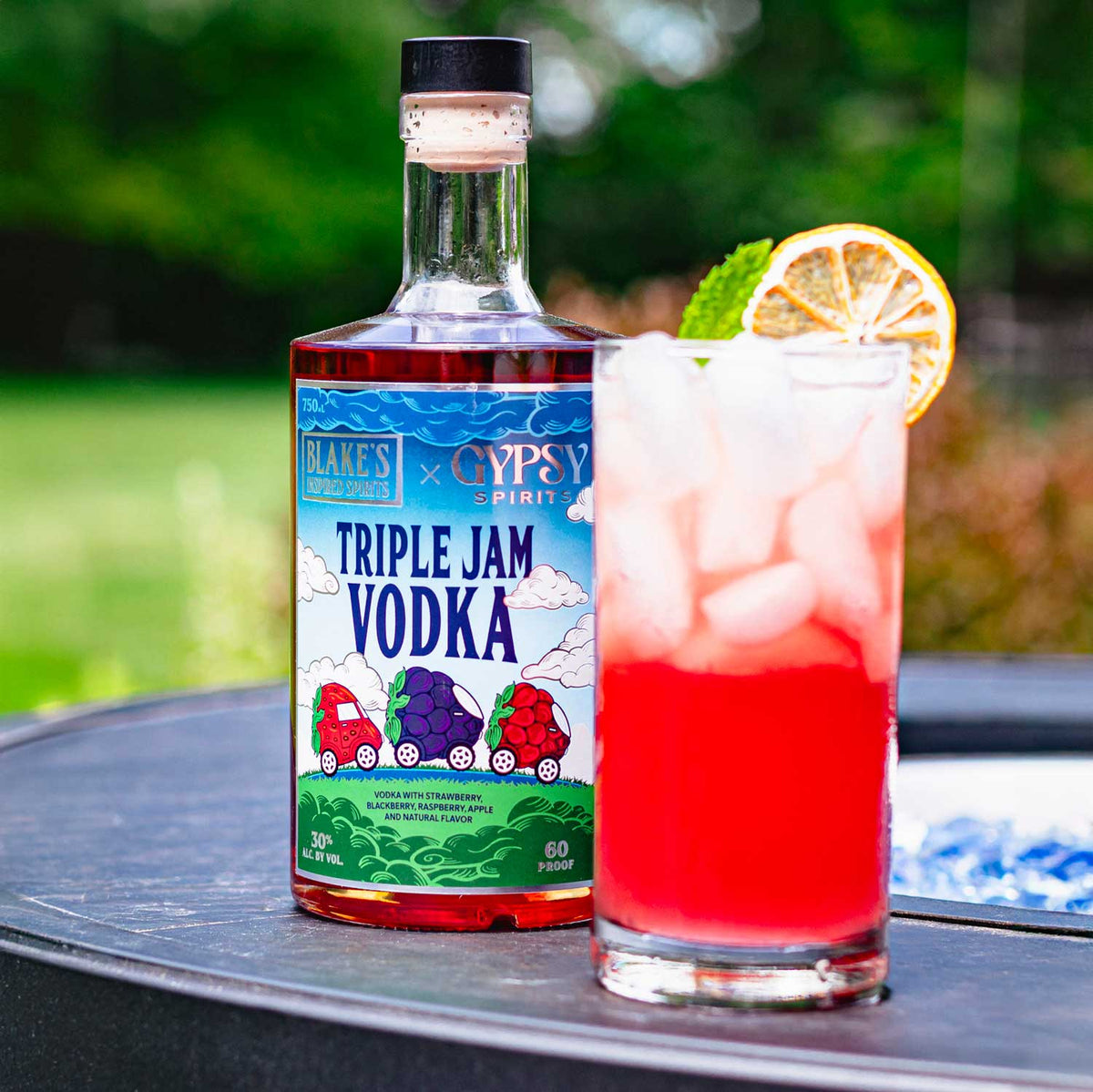 A Berry Hard Lemonade cocktail beside a bottle of Blake's x Gypsy Spirits Triple Jam Vodka
