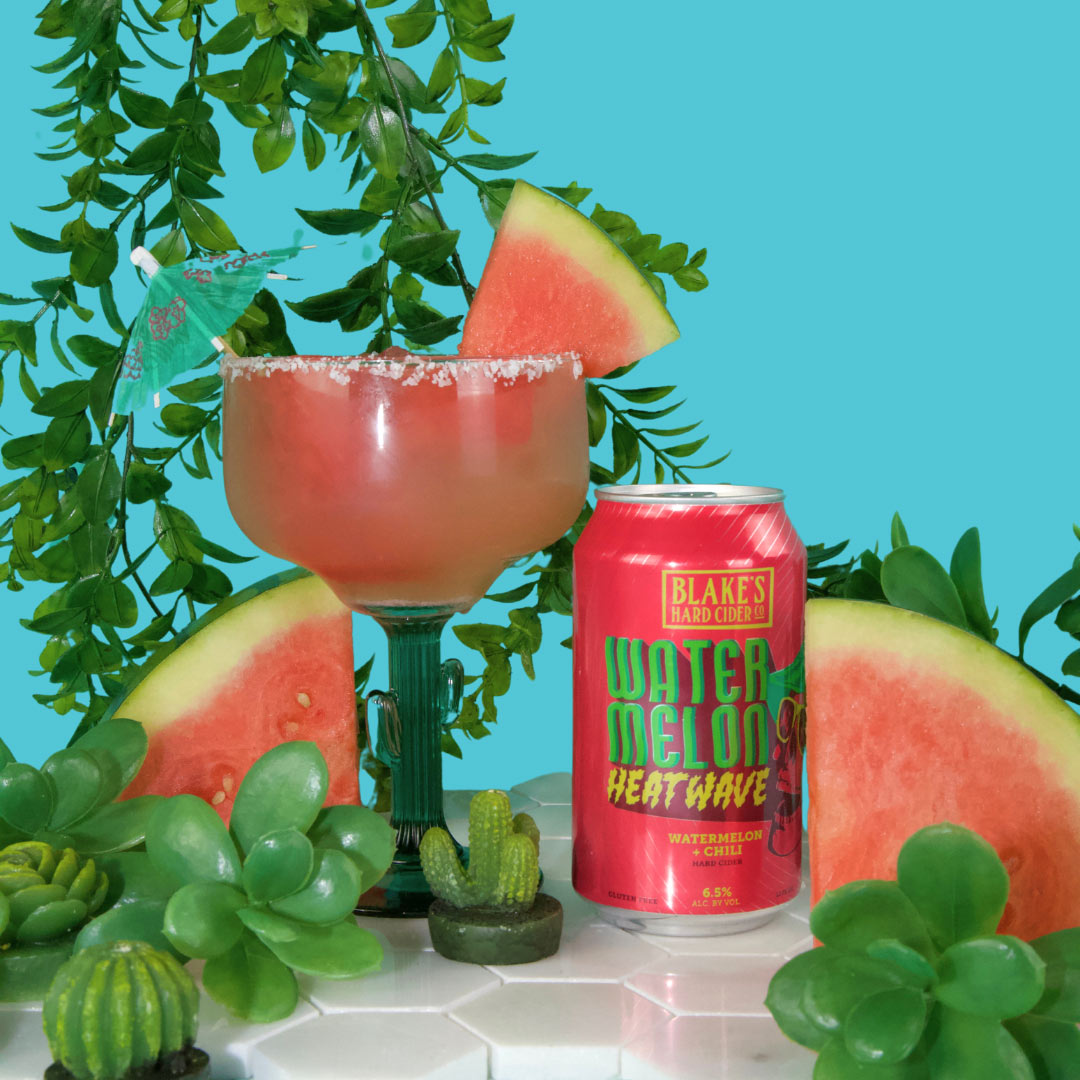 A Sun-Kissed Margarita with a watermelon wedge, beside a can of Blake's Watermelon Heatwave