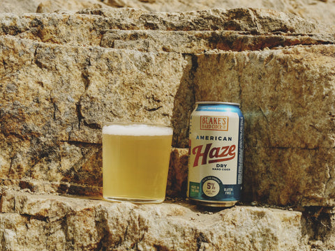 Blake's American Haze can beside a poured glass on a sandstone ledge