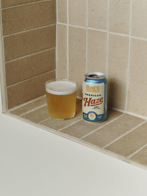 Blake's American Haze can beside a poured glass on a tiled ledge