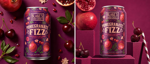 Blake's Hard Cider Pomegranate Fizz can among pomegranates and cherries